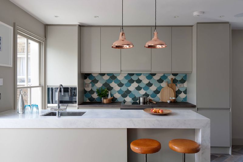 Copper Pendant Lights Over Teal Subway Tile