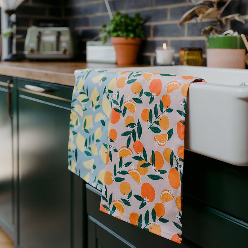 Citrus-Patterned Tea Towels Hung on the Oven Door