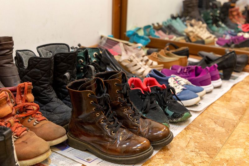 Overflowing Shoe Collection By The Door