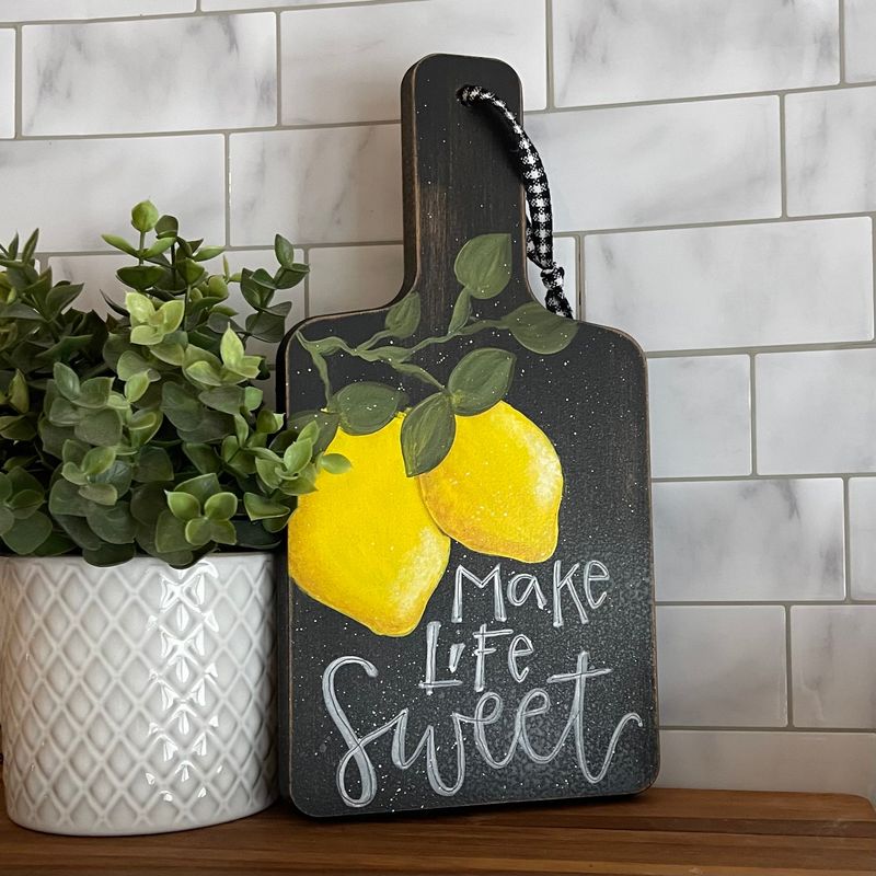Lemon-Shaped Cutting Boards Displayed on Hooks