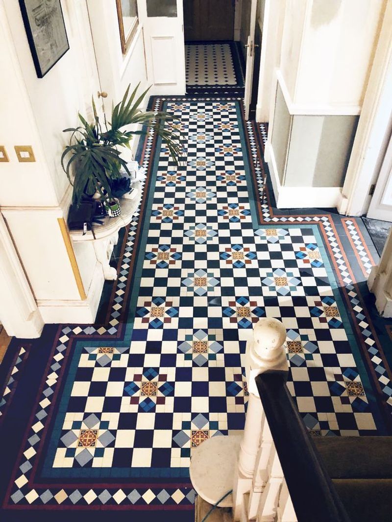 Compact Vestibule with Mosaic Tile and Mirror in a 1930s Flat
