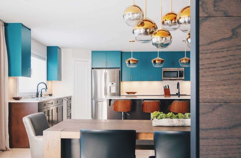 Minimalist Kitchen with Teal Lacquer and Copper Lighting