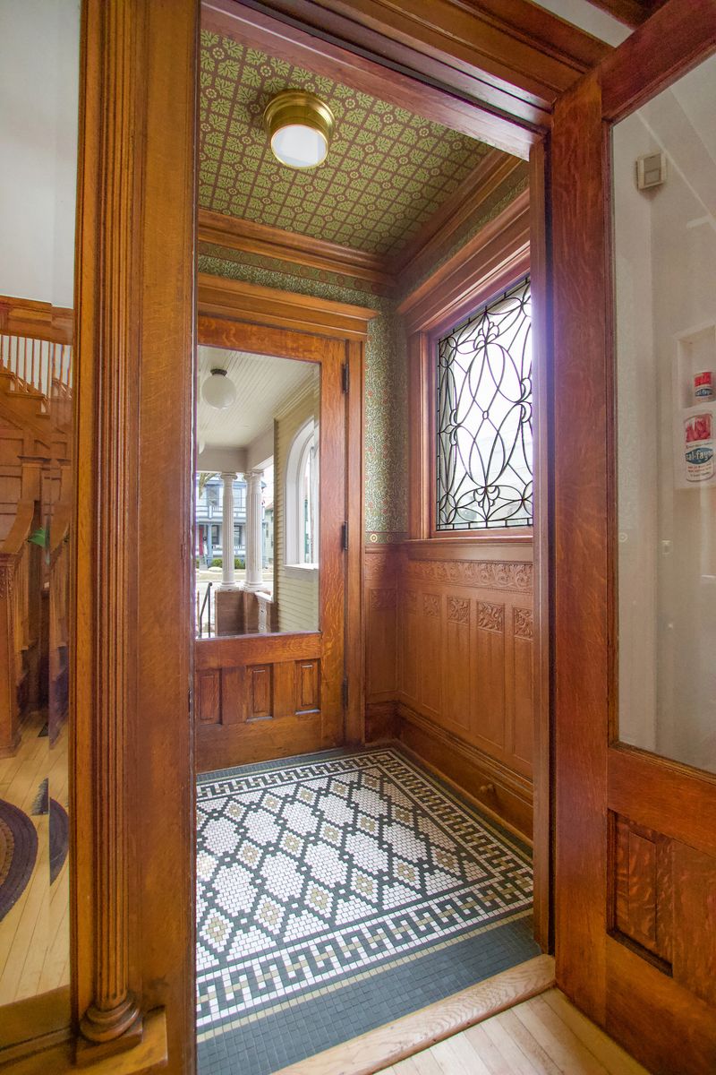Wood-Paneled Vestibule with Built-In Bench in a Victorian Cottage