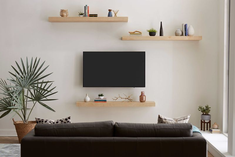 Integrate floating shelves for décor and tech