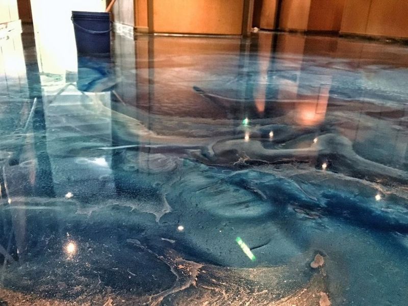High-Gloss Teal Floor Reflecting Copper Accents Above